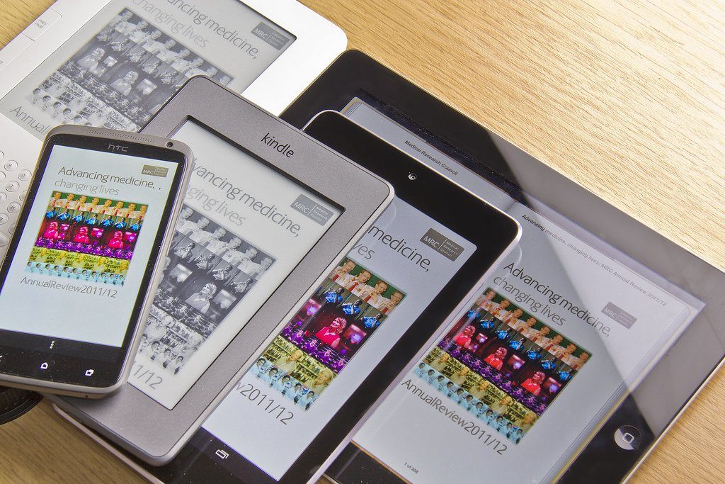E-readers and tablets displaying borrowed library books