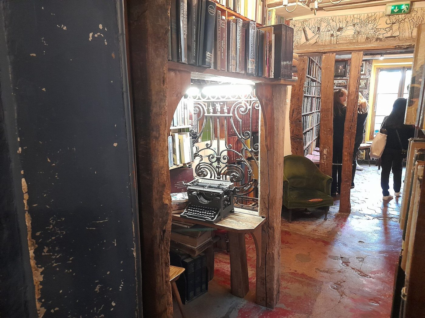 A dim, shadowed room lined with old books