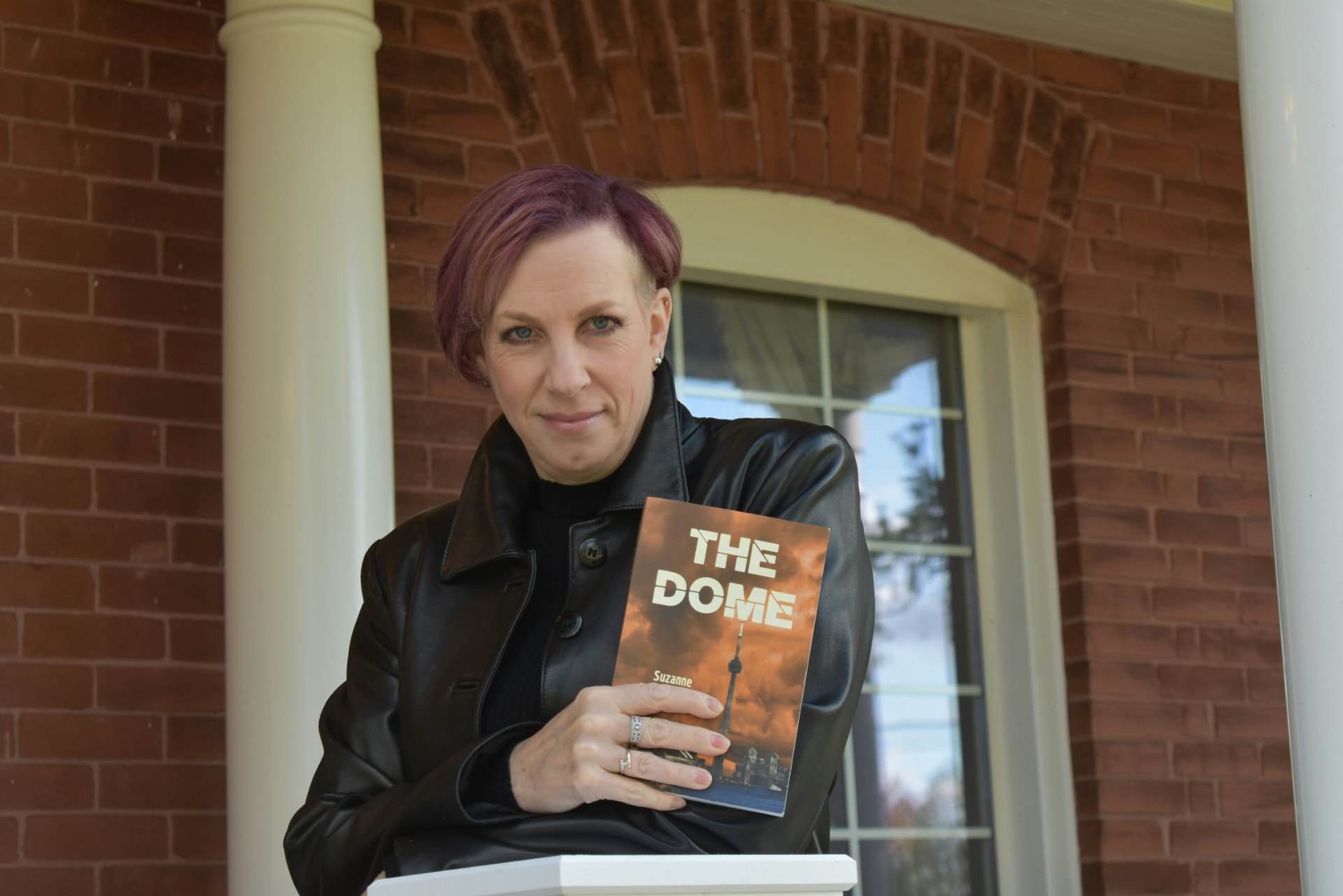 Independent author holding a copy of her published novel