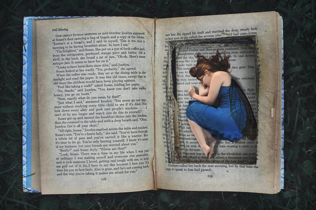 Open fantasy book with an illustrated world inside