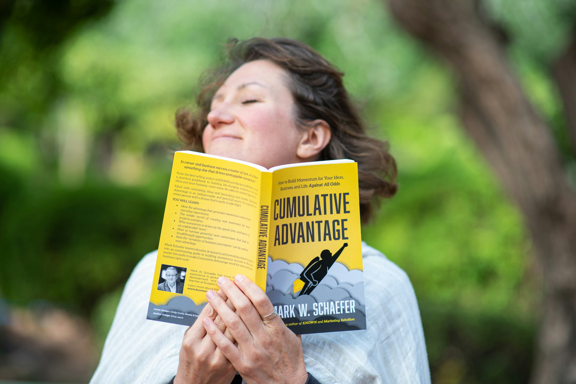 Reader smiling while holding an open book