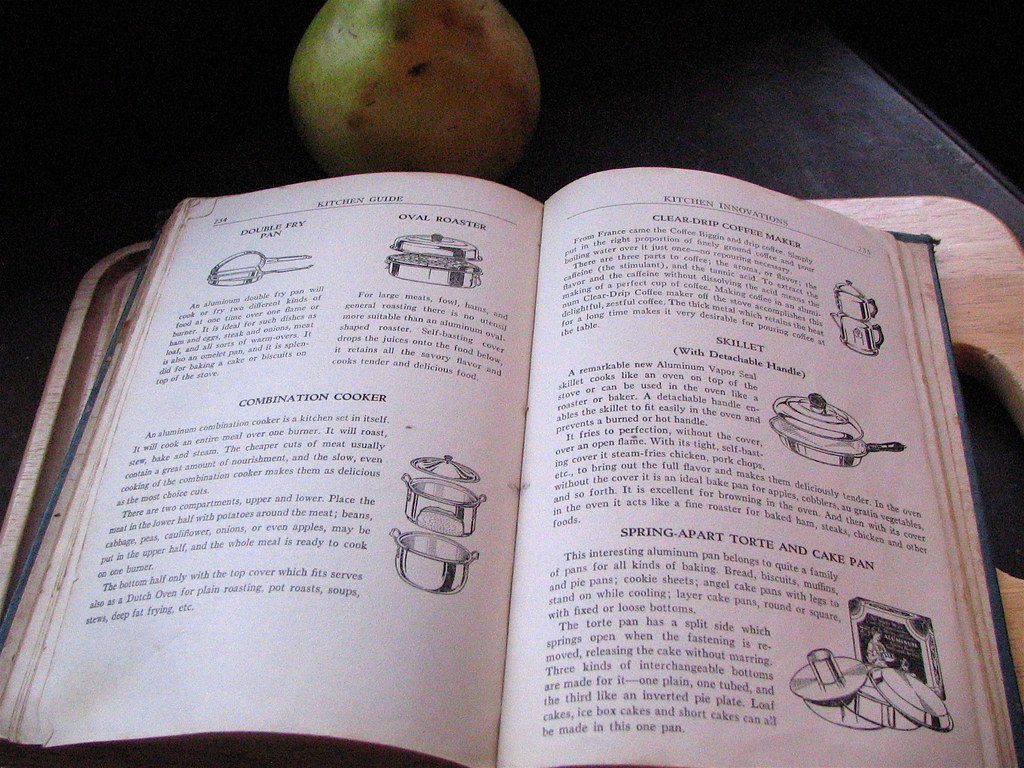 An open vintage cookbook showing recipes and diagrams