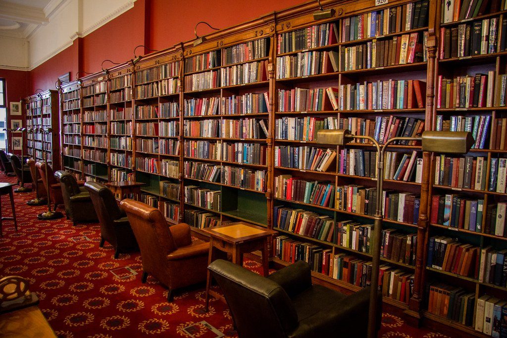 A public library reading room lined with books