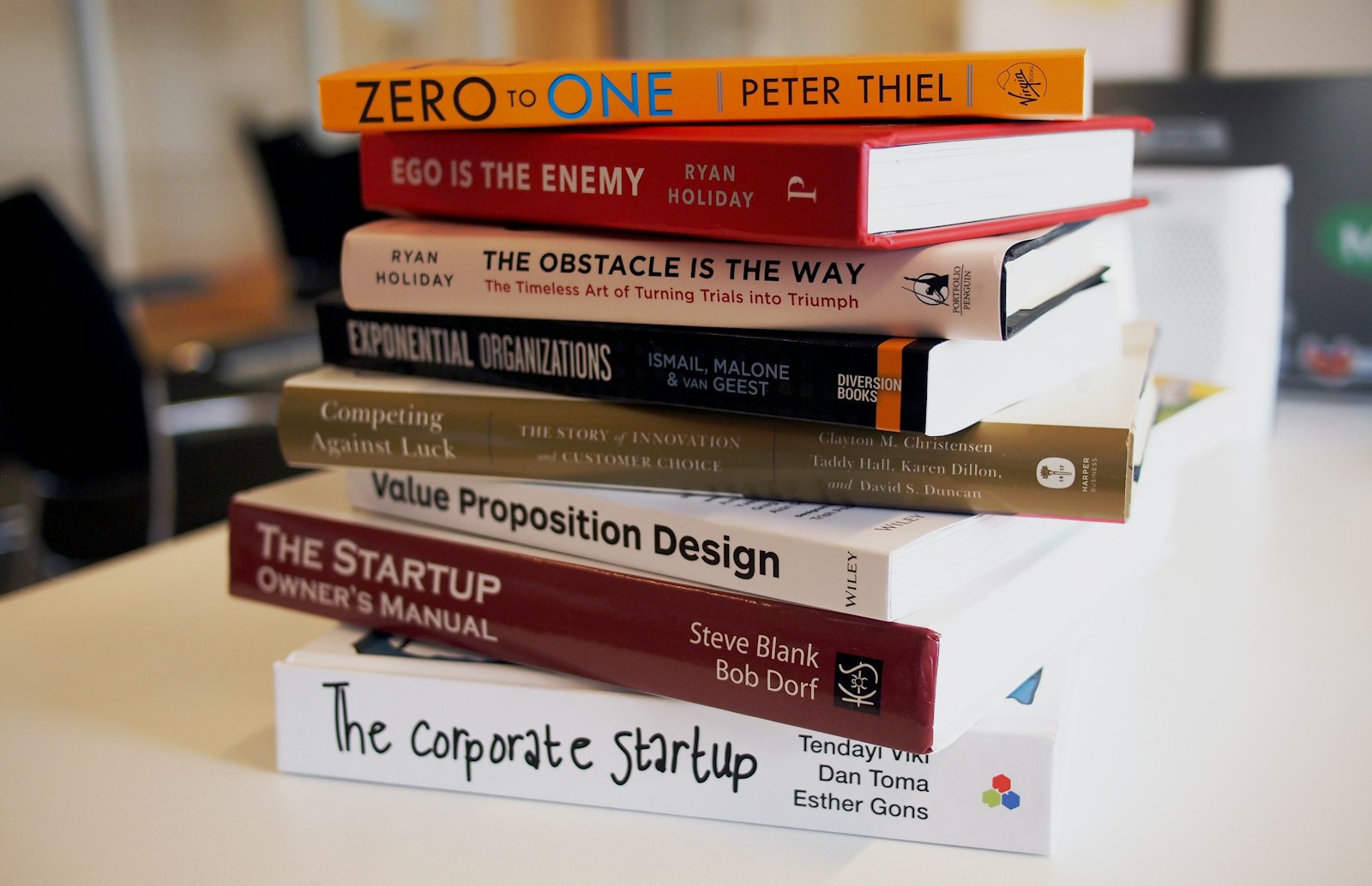Stack of published books resting on a desk